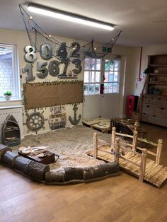 a living room filled with lots of furniture and decor on top of a hard wood floor