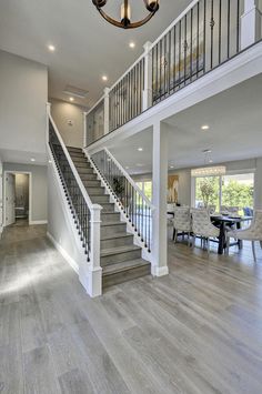 a large open floor plan with stairs leading up to the second story