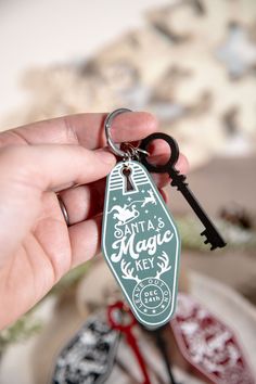 a person is holding a keychain with the words seattle magic key on it