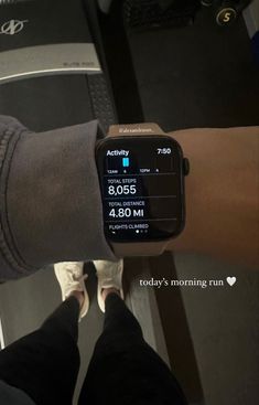 a person wearing a smart watch on their arm with the time displayed in front of them