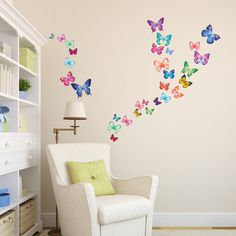 a living room with a white chair and colorful butterflies on the wall