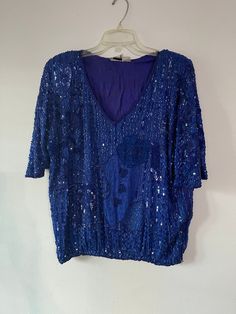 Vintage 90s royal blue silk sequin beaded v neck blouse. Made in India. Cotton candy label. Shoulder pads. Tag size small. Fits small to medium.  Lined.  Arm pit to arm pit = 24 Length = 24 There may be a bead missing here or there. Good condition. Blue V-neck Blouse For Evening, Blue V-neck Blouse For Party, Embellished V-neck Tops For Party Season, Blue Sequin Top For Party Season, Blue Sequin Tops For Party Season, Embellished Blue V-neck Top, Blue Embellished V-neck Top, Blue V-neck Party Top, Blue V-neck Tops For Party