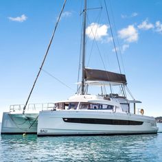 a catamaran sailing in the ocean on a sunny day