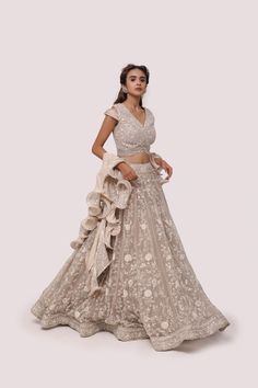 Alluring bone white embroidered net and and organza lehenga is a beautiful choice for weddings and festive occasions. It is crafted with sequin, thread, pearl and cutdana work and comes with a wavy wired dupatta. Shop online from Pure Elegance. Disclaimer: The actual product may vary slightly from the image. These are custom orders, hence expect slight variation in color, placement of the motif or buta. ESTIMATED DELIVERYBecause this is a custom order, it would take about 4 weeks from the date o Lace Choli With Intricate Embroidery For Reception, Lace Choli With Resham Embroidery For Reception, Lace Anarkali Set With Intricate Embroidery For Reception, Festive Lace Lehenga With Lace Work, Lace Choli With Sheer Dupatta For Reception, Designer Lace Lehenga With Zari Work, White Organza Lehenga With Lace Work, Designer Lace Lehenga With Resham Embroidery, Designer Wear Organza Lehenga With Lace Work