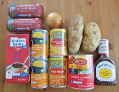 an assortment of canned food on a wooden table