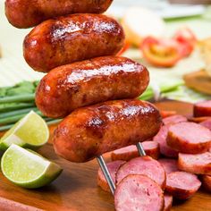 several sausages and vegetables on a cutting board