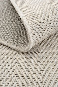 a close up view of a white rug