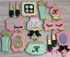 decorated cookies are arranged in the shape of purses and makeup accessories for birthday girls