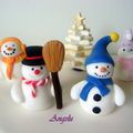 three snowman figurines sitting next to each other