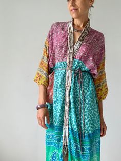 "This is mid length patchwork robe, with long puff sleeve super comfy wrap tie free size house colorful duster Made of vintage lightweight silk materials with different patterns Always one of a kind, perfect on your holiday at the beach or as a house  cover up  Easy to wear and flowy MEASURE Shoulder up to 23\" Bust up to 42\" Waist up to 42\" Length 40\" MATERIAL *up-cycled vintage silk For more boho style ideas please visit also  https://www.etsy.com/uk/shop/Gyaki CARE INSTRUCTIONS  Wash separ Multicolor Patchwork Kimono For Spring, Multicolor Long Kimono For Loungewear, Bohemian Multicolor Robe For Spring, Multicolor Bohemian Robe For Spring, Green Patchwork Kimono For Spring, Long Sleeve Multicolor Robe For Summer, Long Sleeve Patchwork Kaftan For Summer, Summer Long Sleeve Kaftan With Patchwork, Bohemian Long Sleeve Kaftan With Patchwork