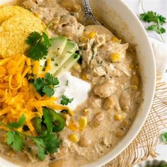 a white bowl filled with chicken and tortilla soup