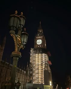 the big ben clock tower towering over the city of london, england at night time