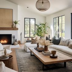 a living room filled with furniture and a fire place in the middle of the room