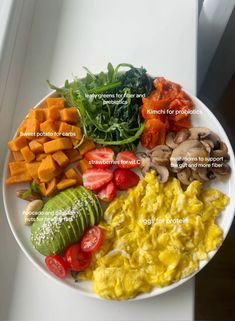 a white plate topped with different types of food on top of a window sill