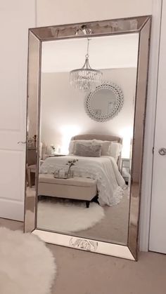 a bedroom with a large mirror on the wall