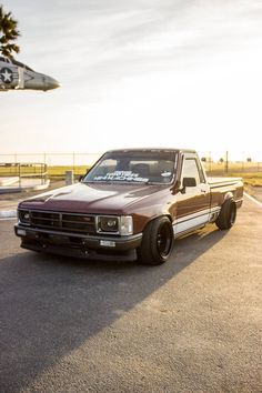 a truck is parked in the parking lot near an airplane that has just taken off