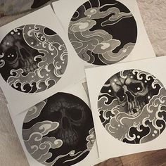 four black and white stickers with designs on them