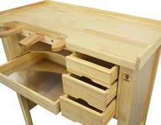 an unfinished wooden desk with drawers on one side and two open compartments in the other