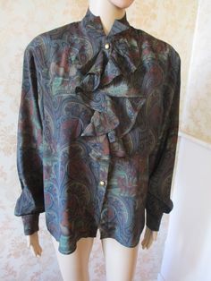 "fabulous silk mix paisley shirt with a high neck and a ruffled front.  It has long blouson sleeves with silver buttons to close and on the cuffs.  There is slight padding on the shoulders which is removeable,  the pattern is paisley with a subtle hunt pattern.  Very good condition. Bust flat;  22\" Inside sleeve;  19\" Length;  28\" Made by BLEU MARINE DESIGN" Fall Silk Blouse With Ruffles, Vintage Long Sleeve Blouse For Fall, Long Sleeve Blouse For Vintage Fashion In Fall, Long Sleeve Blouse For Fall Vintage Fashion, Fitted Ruffle Blouse For Fall, Formal Fall Blouse With Ruffled Collar, Formal Silk Top With Ruffled Collar, Silk Ruffled Tops For Fall, Silk Top With Ruffled Collar For Formal Occasions