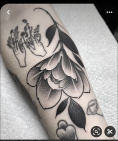 a black and white flower tattoo on the arm