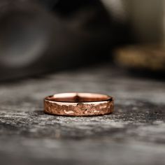 a close up of a wedding ring on a wooden surface