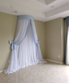 an empty room with drapes and curtains