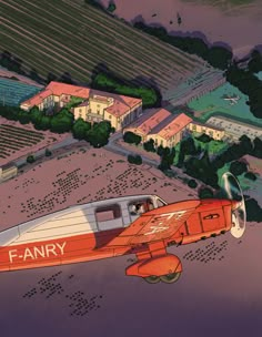 an orange and white airplane flying over a small town