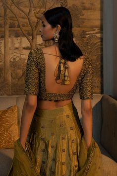 Moss green half sleeve padded blouse with antique gold cutdana, zardozi embroidery in scallop pattern. Paired with embroidered attached cancan lehenga and dupatta. 
Components: 3
Pattern: Embroidery
Type Of Work: Cutdana, zardozi, scallop
Neckline: Scallop V neck
Sleeve Type: Half sleeves
Fabric: Blouse and Lehenga: Tissue Silk, Dupatta: Net
Color: Green
Other Details: 
Model height: 5 ft 8 inches, wearing size XS
Lehenga:
Attached cancan
Length: 45 inches
Blouse:
Padded
Inverted V hem
Back tass Scallop Neckline, Cancan Lehenga, Scallop Pattern, Zardozi Embroidery, Padded Blouse, Bridal Lehengas, Pattern Embroidery, Silk Dupatta, Silk Embroidery