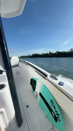 the inside of a boat with a surfboard on it's back end in the water