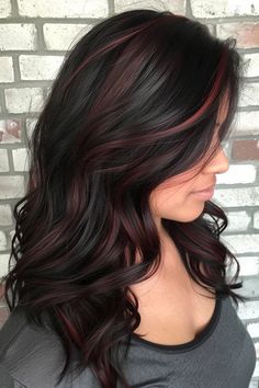 Check out the collection of 45 black and red hair ideas we just posted on our blog. From the subtle red highlights you see here to copper balayage and black/wine red split dye looks, you'll find a ton of hair inspiration in our latest article. Click the pin to see it now and follow us for more ideas! Black Hair With Red Pieces, Black Hair With Red Highlights Bangs, Cinnamon Highlights On Black Hair, Black Cherry Hair Balayage, Subtle Red Highlights In Black Hair, Jet Black Hair With Red Highlights, Red Lowlights In Black Hair, Dark Red Highlights In Brown Hair Burgundy Low Lights, Dark Brown Hair With Dark Red Highlights