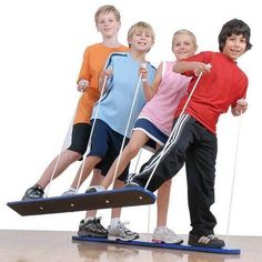 four children are standing on an exercise mat and holding handles to pull the rope with their hands