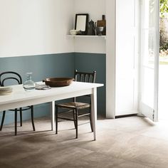 a dining room table with plates and bowls on it