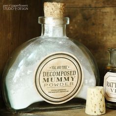 an old fashioned bottle is sitting on a shelf next to some other bottles that have labels on them