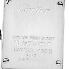 Cartier Tank Americaine White Gold Diamond Ladies Watch WB710013. Quartz movement. 18K white gold case 15.2 x 27.0 mm with 2 rows of original Cartier factory diamonds on the sides. Circular grained crown set with faceted diamond. . Scratch resistant sapphire crystal. Silver guilloche dial with black Roman numeral hour markers and an inner minute track. Sword-shaped blue hands. Secret Cartier signature at VII. 18K white gold bracelet with hidden butterfly clasp. Fits a 6 1/4" wrist. Luxury White Gold Diamond Watch With Date Display, Anniversary White Gold Diamond Watch With Date Display, Designer White Gold Watches For Anniversary, Cartier Rectangular Watch Accessories For Anniversary, Silver Cartier Watch For Wedding, Silver Rectangular Diamond Watch For Anniversary, Anniversary Diamond Watch With Rectangular Dial In White Gold, Anniversary Engraved White Gold Diamond Watch, Designer Silver Watch With Date Indicator