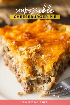 a piece of meat and cheese casserole on a white plate with a fork