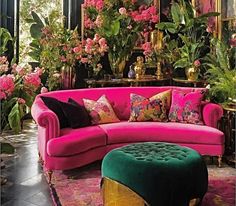 a living room filled with pink couches and lots of flowers