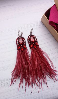 Very bright and light earrings with natural ostrich feathers, embroidered with Swarovski crystals and Czech beads. In my work, I used LK materials. The clasp is hypoallergenic. They will suit both an evening dress and a business look. Gift wrap. Upon request, I can sign a postcard with your text. You still have questions, just write to me. Very delicate and light earrings with natural ostrich feathers, embroidered with Swarovski crystals and Czech beads. In my work, I used LK materials. The clasp is hypoallergenic. They will suit both an evening dress and a business look. You still have questions, just write to me. Light Earrings, Red Earrings, Long Red, Ostrich Feathers, Business Look, Czech Beads, Gift Wrap, Evening Dress, Jewelry Earrings Dangle