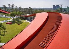 an aerial view of a red building with stairs leading up to it's roof