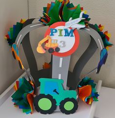 a paper model of a tractor with a sign that says pim on the front