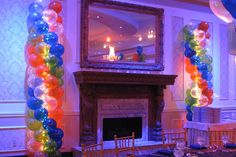 a room filled with balloons and a fire place