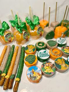 many different items are arranged on the table with green bows and yellow candies in glass vases