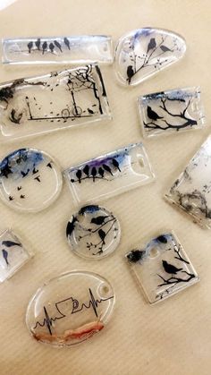 some glass magnets with black and white designs on them