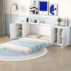 a white bed sitting on top of a hard wood floor next to a book shelf