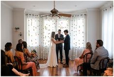 a bride and groom standing at the alter during their wedding ceremony in front of an audience