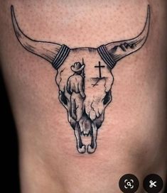 a bull skull with a cross tattoo on it's side ribcadings