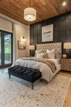 a bedroom with a large bed and wooden ceiling