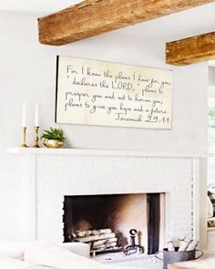 a living room filled with furniture and a fire place in front of a white fireplace