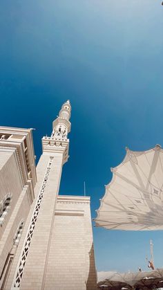 two large umbrellas sitting in front of a tall building