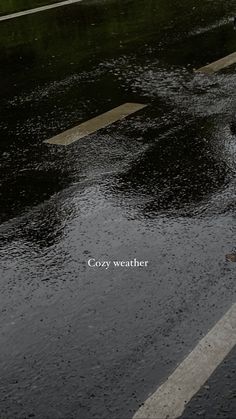 a person walking down the street in the rain with an umbrella over their head and text that reads cozy weather