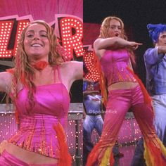 two women in pink outfits are dancing on stage